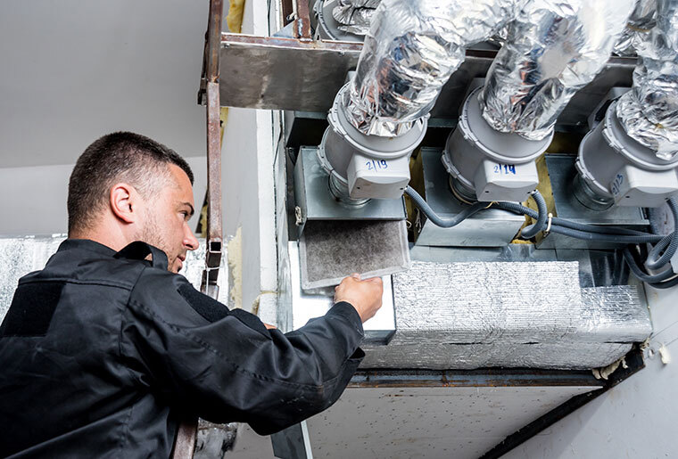 Man servicing HVAC unit