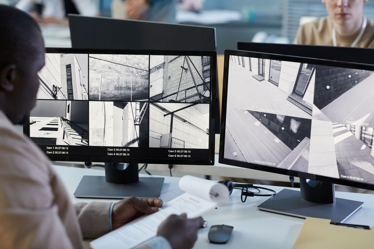man at security and monitoring center desk