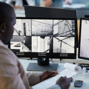man at computer monitoring building systems
